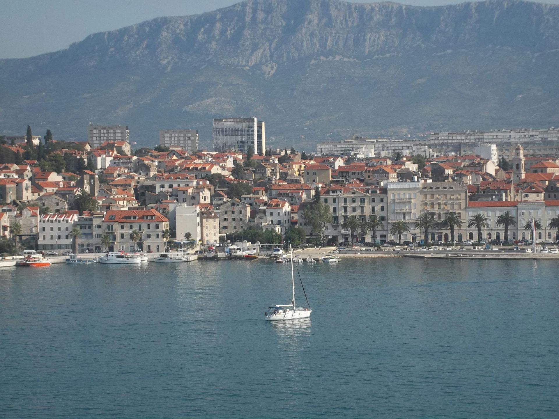 Beautiful Split coastline with sailboat and mountains in Croatia.