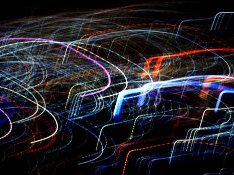 Vibrant abstract image featuring colorful light trails against a dark background.