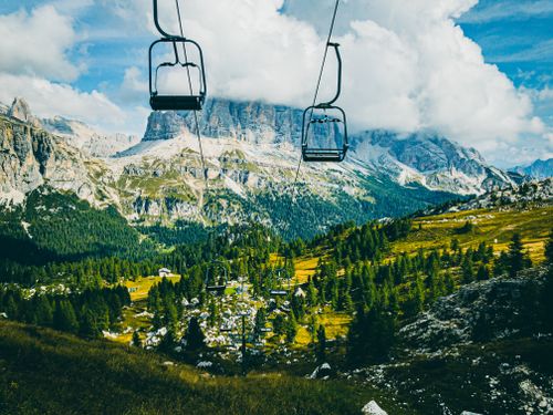Free Breathtaking view of the Dolomites and lush green valleys from a cable car in Cortina d'Ampezzo, Italy. Stock Photo