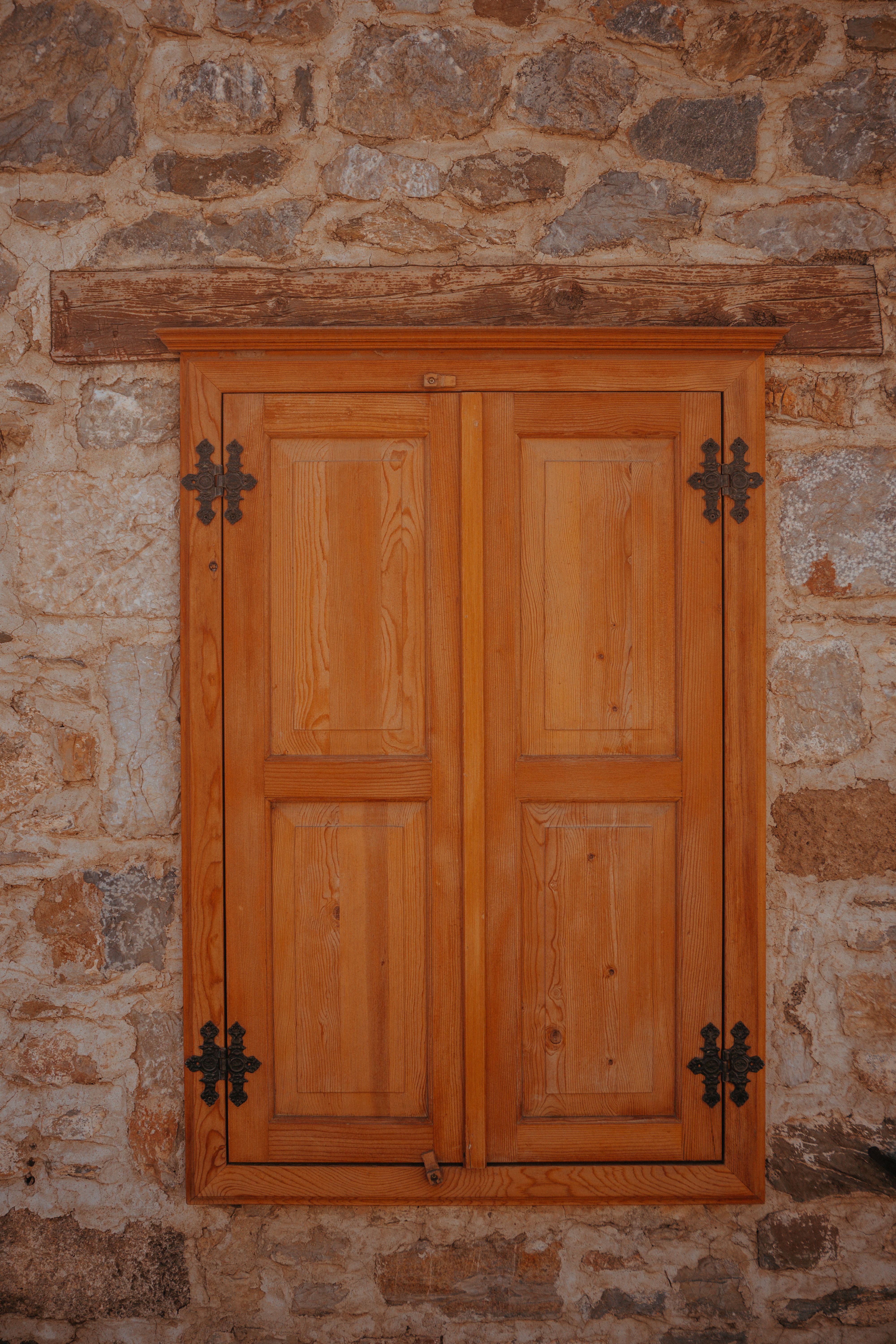 Wooden Window with Closed Shutters in a Stone Wall · Free Stock Photo