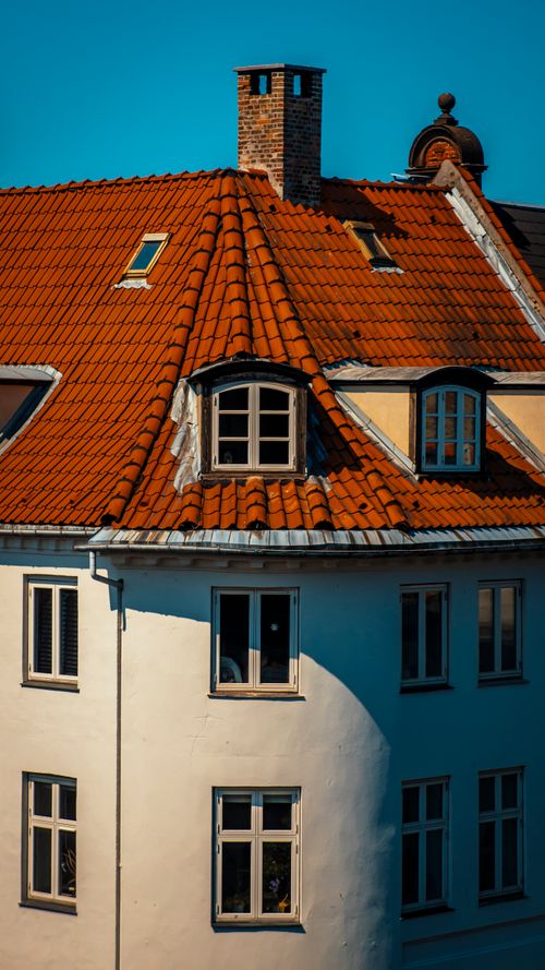 Free A picturesque view of a brick-red roofed residential building in Copenhagen, Denmark. Stock Photo