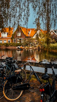 A beautiful view of Volendam with bicycles by a canal, showcasing Dutch architecture.