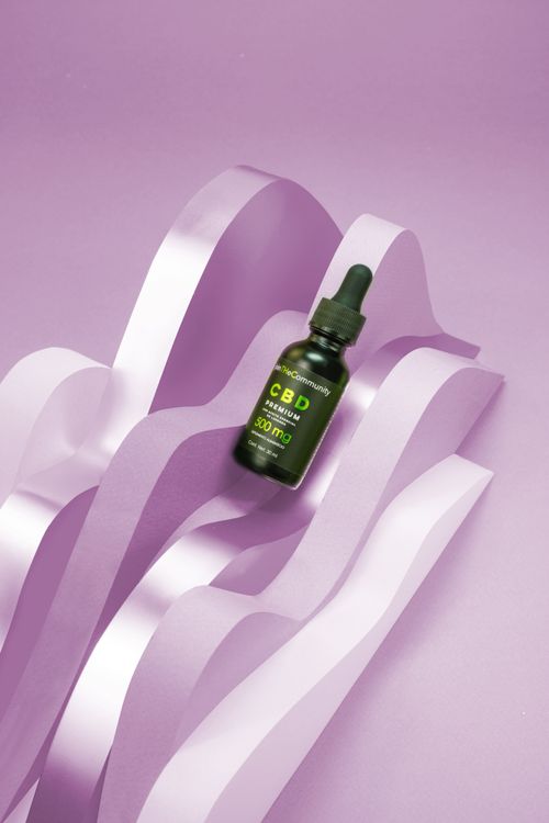 Free CBD serum vial on creative purple waves background. Perfect for skin care or health visuals. Stock Photo