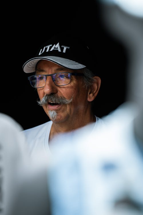 Portrait of a Senior Man in Baseball Cap and Eyeglasses