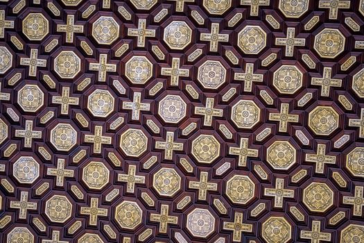 Detailed view of a geometric and ornate ceiling pattern in Seville, Spain.