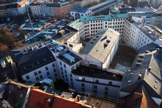 Aerial view of Munich's urban landscape showcasing distinctive rooftops and city design.