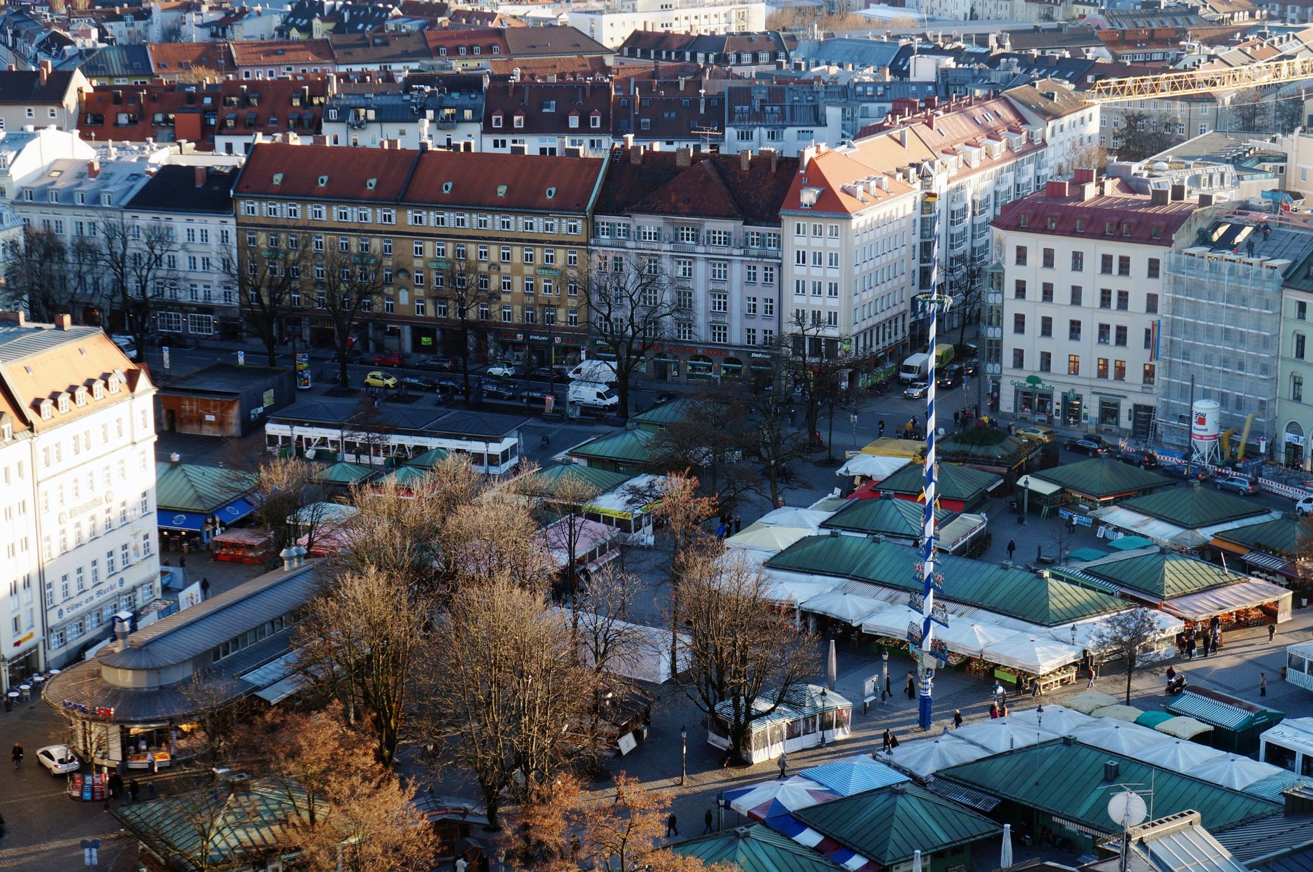 Explore the lively Viktualienmarkt in Munich's historic city center, surrounded by beautiful architecture and bustling activity.