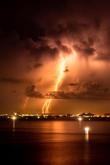 Lightning splitting a night sky — photo by Xuan Thong Tran on Pexels