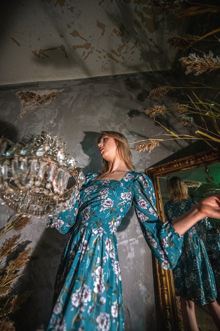 Low Angle Shot Of A Woman In Blue Dress And Her Reflection In The Mirror 