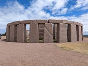 Stonehenge-like structure in Esperance, Australia under clear blue skies, surrounded by open fields.