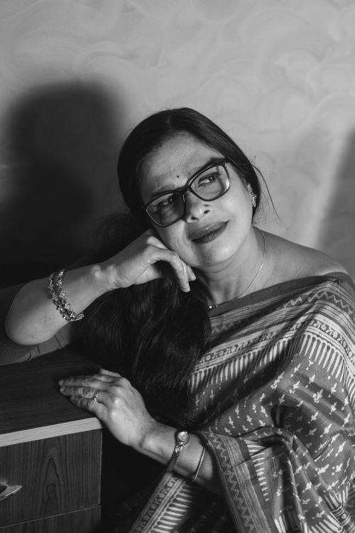 Free Black and white portrait of a smiling woman in a traditional saree, exuding grace. Stock Photo
