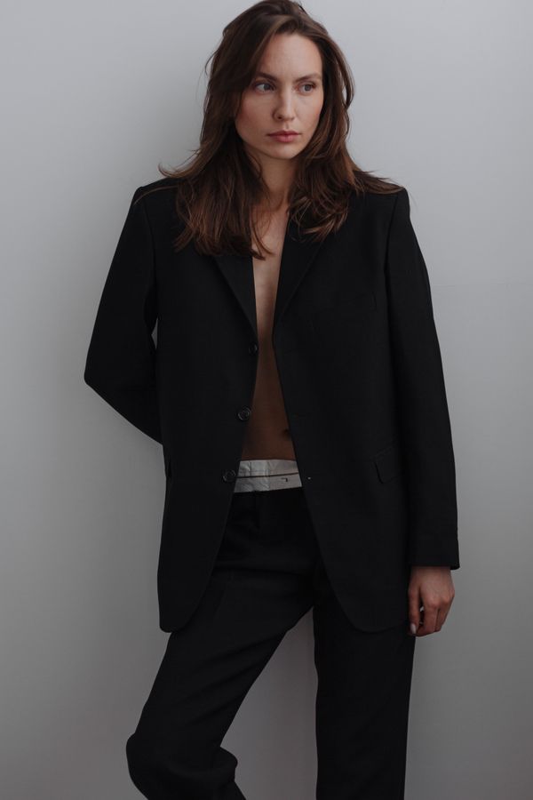 Woman in oversized thrifted menswear blazer