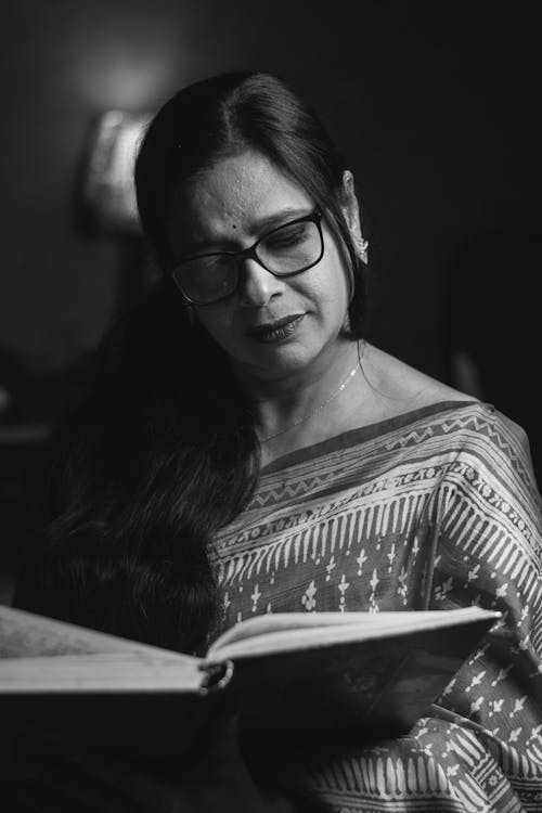 Woman in Eyeglasses Reading Book