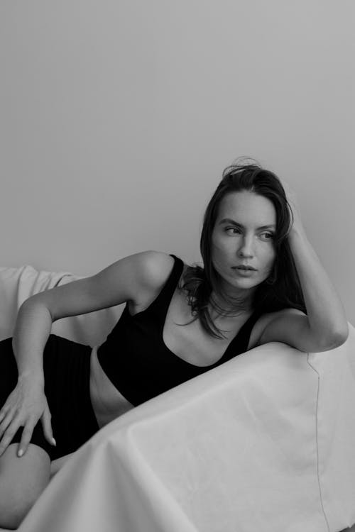 A Model in a Black Lingerie Posing on a White Sofa