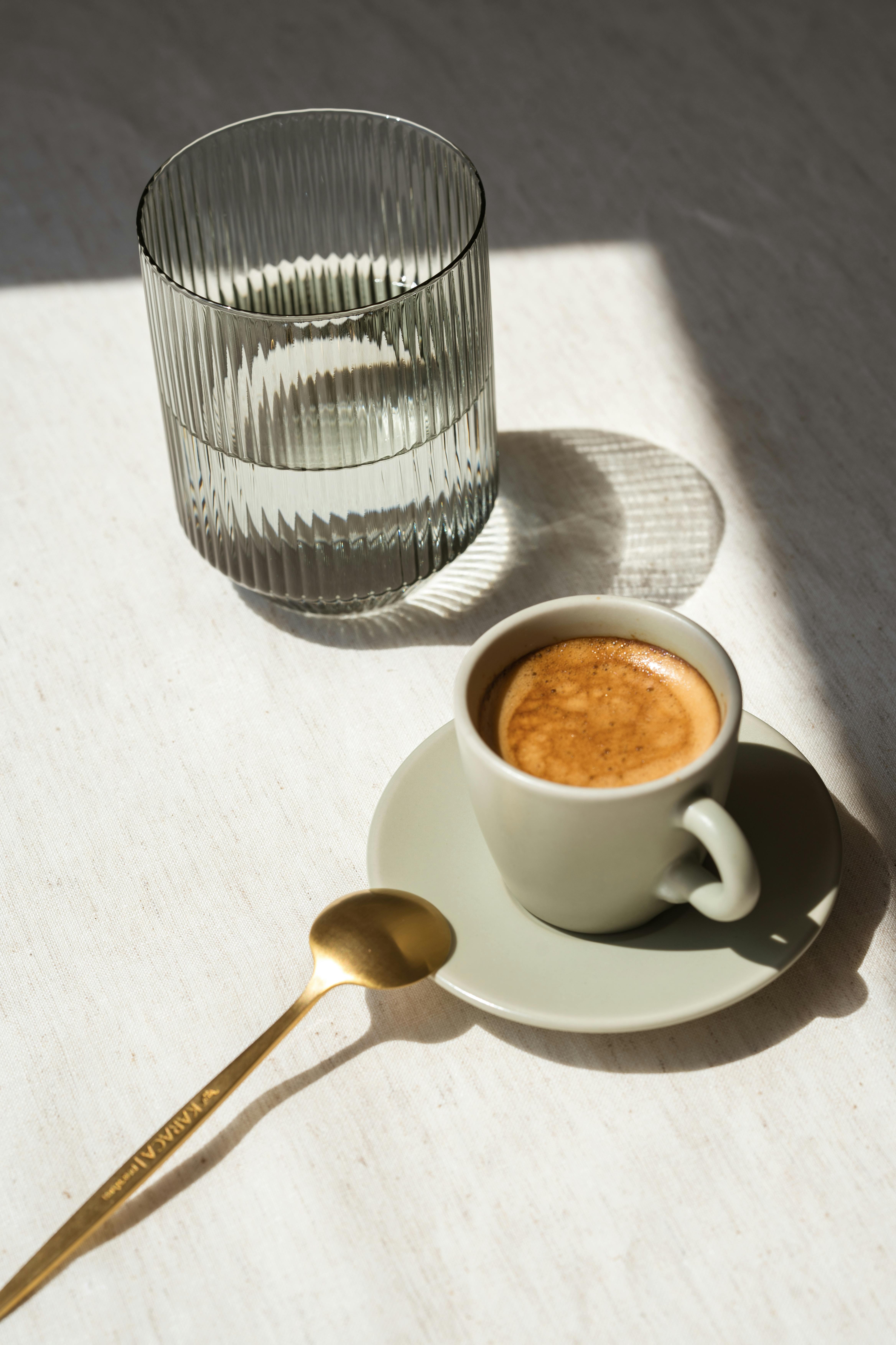 Elegant composition of espresso and water captured with natural light
