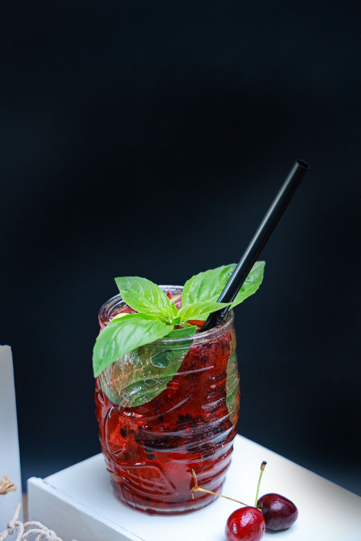 glass of tart cherry juice for sleep on a bedside table