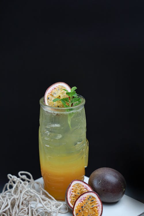 A drink with passion fruit and a slice of lime