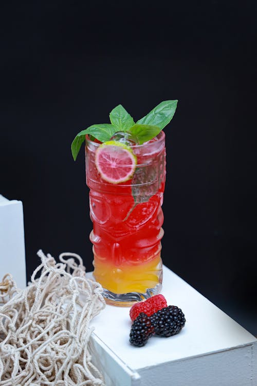 A colorful drink with berries and mint leaves