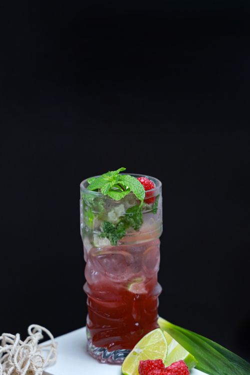 Free A chilled raspberry mint mojito garnished with fresh mint and lime. Stock Photo