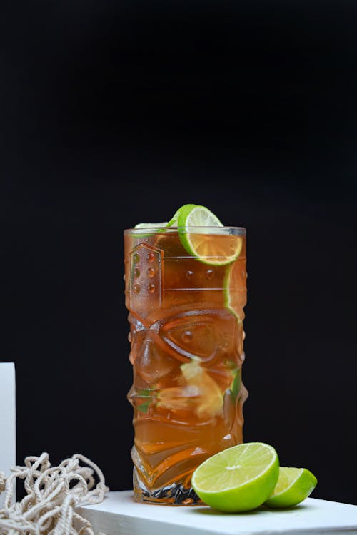 A glass of iced tea with lime slices