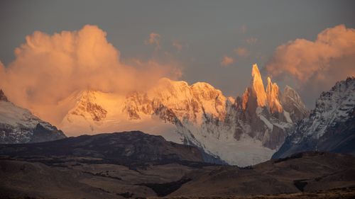 Free Captivating scene of snowy mountains at sunrise, with vibrant skies illuminating the peaks. Stock Photo