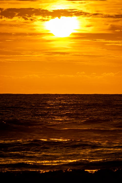 Golden Waves and Orange Sky at Dawn