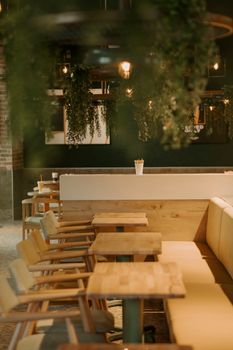 Warm and inviting restaurant interior with wooden chairs and tables.