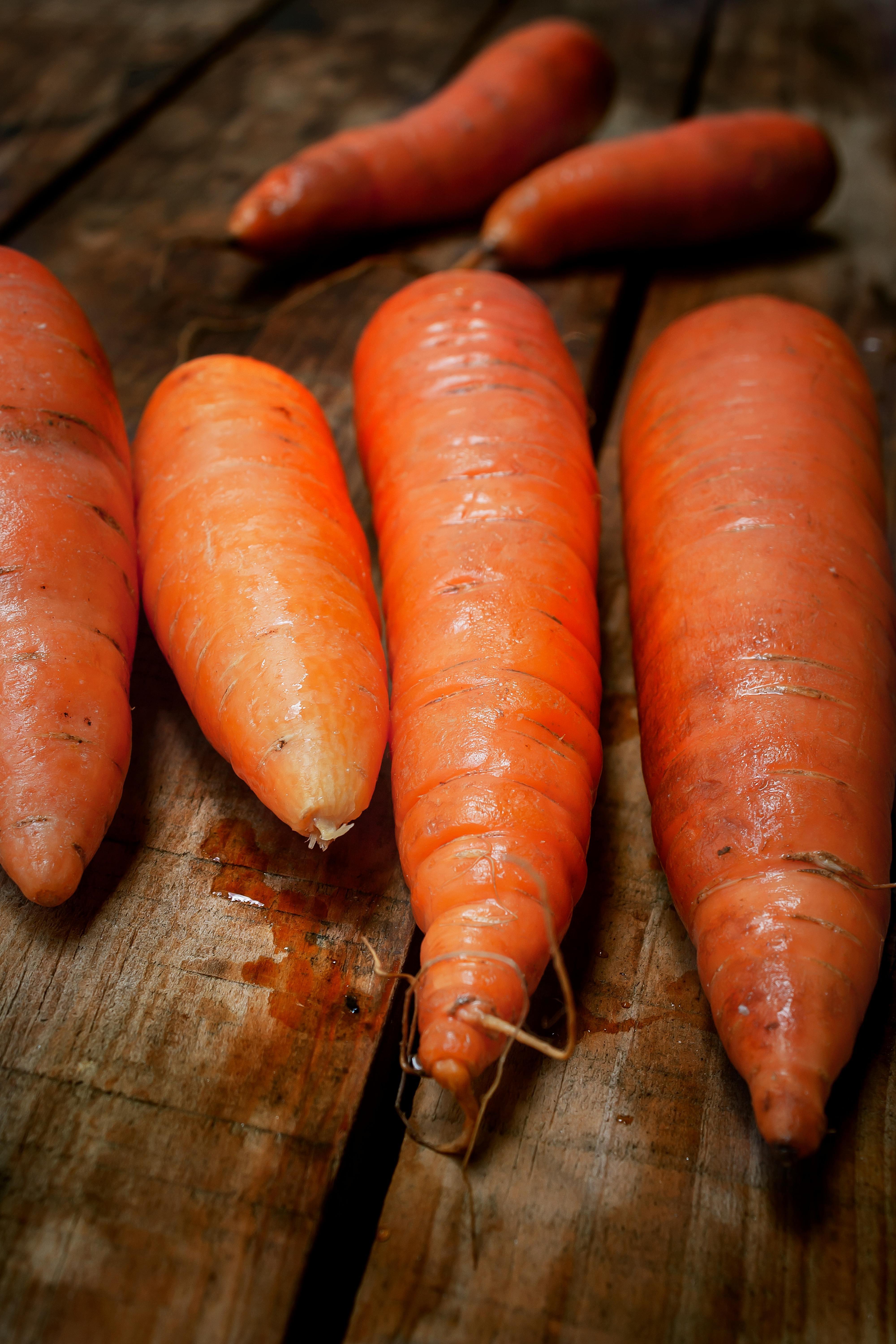 carrots on a wooden table with a knife