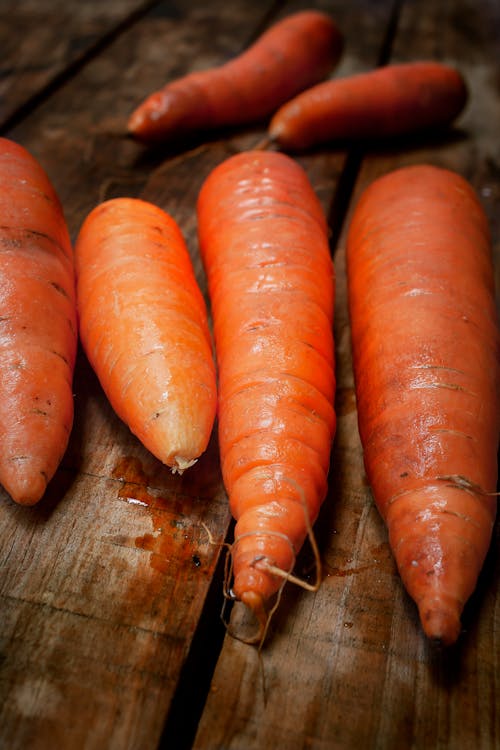 Washed Unscraped Carrots on a Wooden Table Top