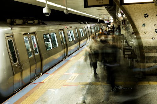 Long Exposure of People Walking on a Subway Platform 