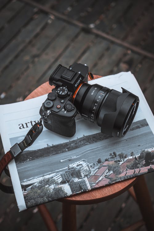 Digital Photo Camera Lying on a Newspaper