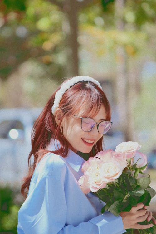 Young Smiling Woman with a Bouquet of Roses