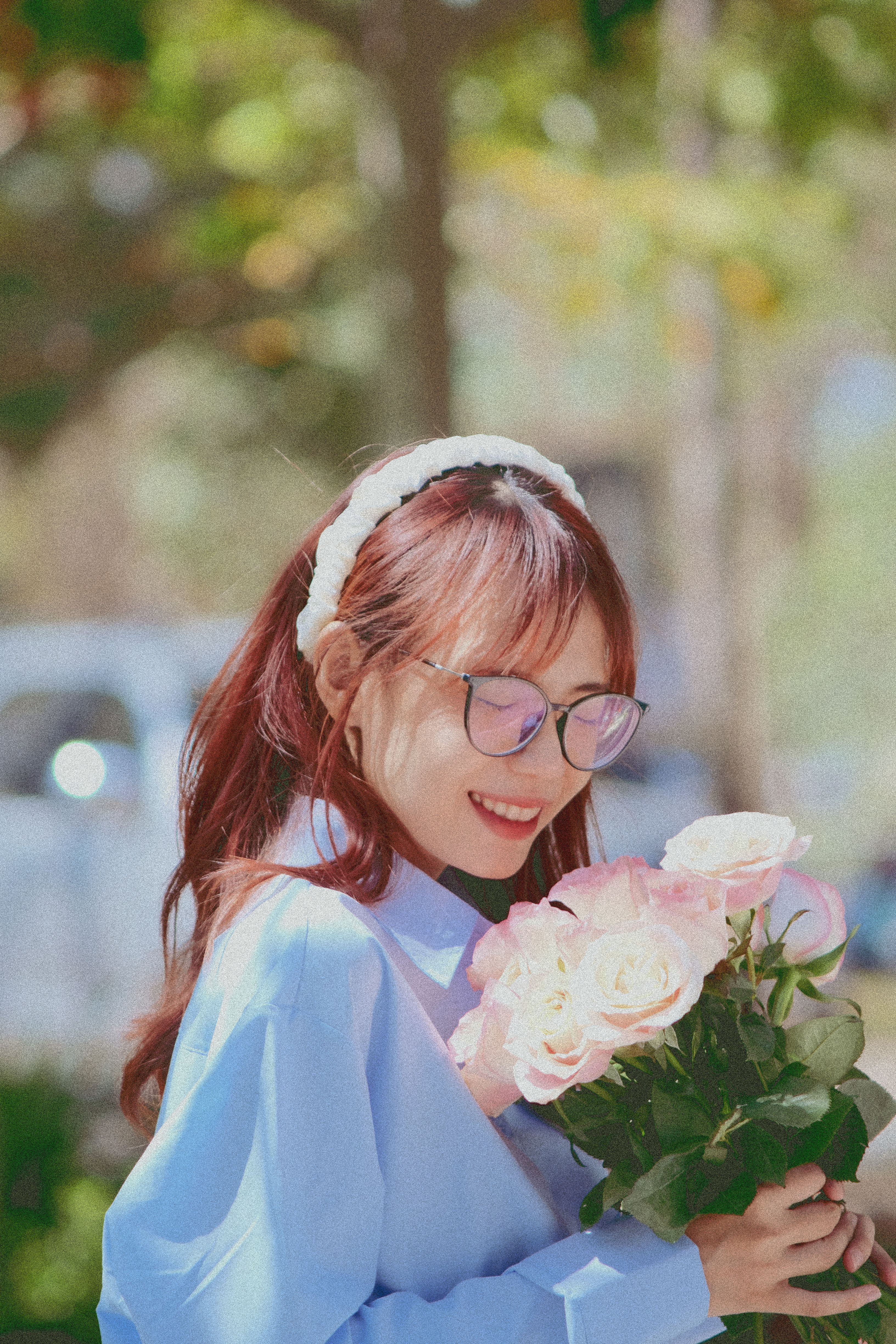 Young Smiling Woman with a Bouquet of Roses · Free Stock Photo