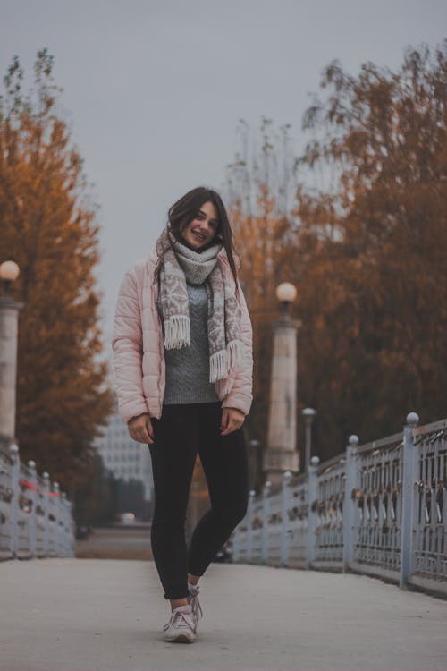 Woman Standing Between Handrails