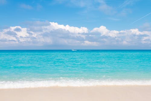 View of Empty Beach and Bright Blue Water 