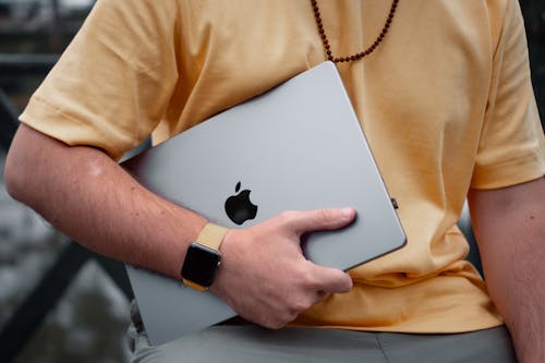 Man Hand Holding MacBook