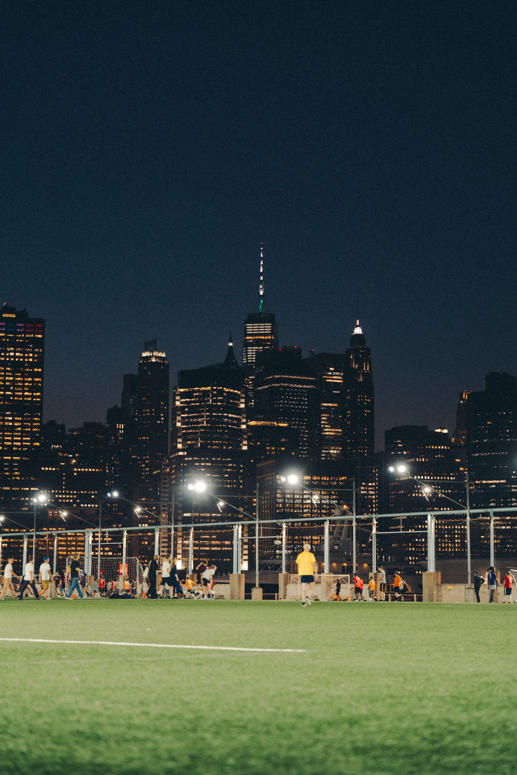 A group of young adults socialising and conversing at an in-person singles networking event in New York City.