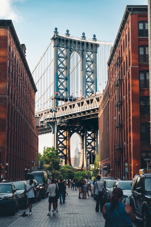 Free People on Street with Brooklyn Bridge behind Stock Photo