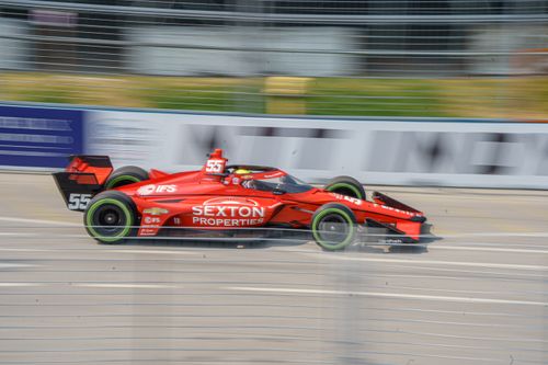 Free Red racing car in motion during a race in Toronto, Canada, showcasing speed and excitement. Stock Photo