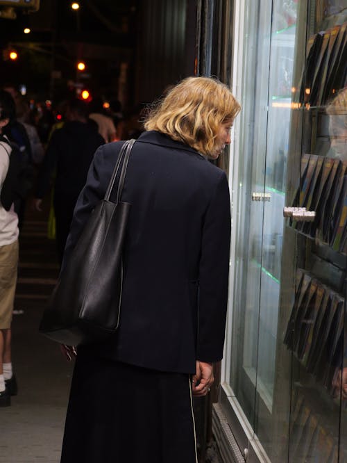 Passerby in a Navy Blue Blazer with a Leather Bag Window Shopping