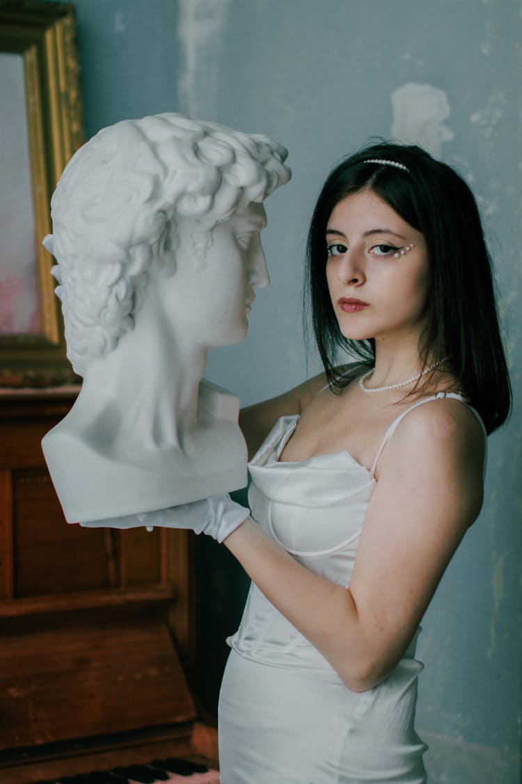 Woman Holding A Sculpture