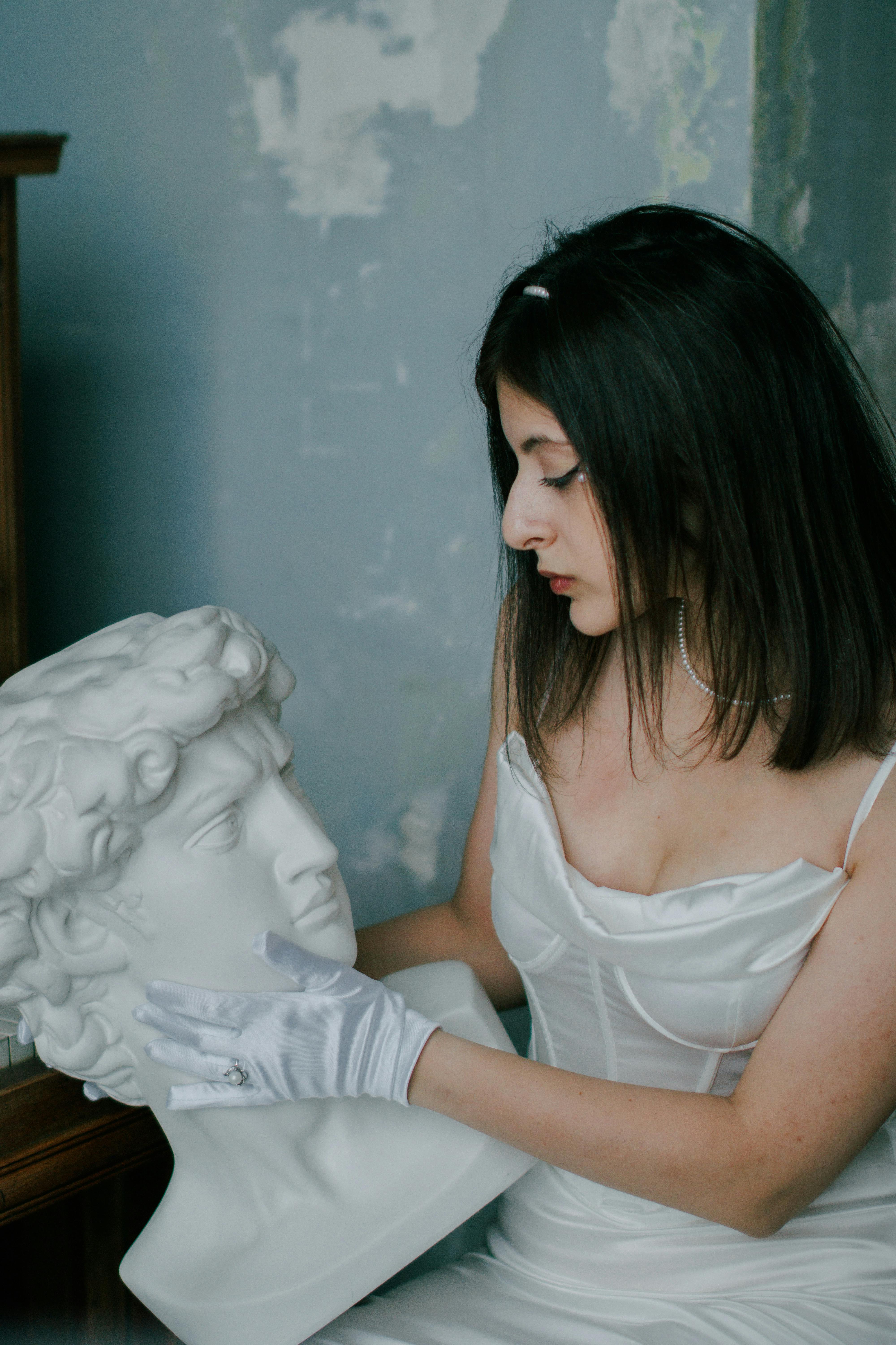 portrait of woman holding sculpture