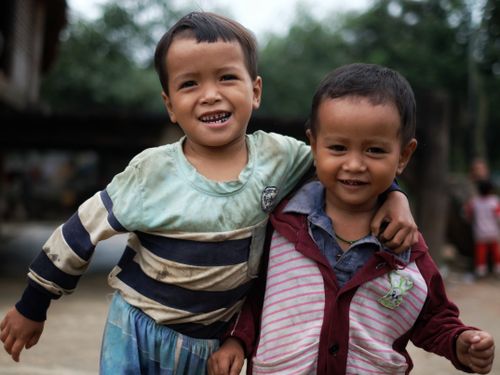 Free Two smiling boys with dirty clothes enjoying their friendship outdoors. Capturing a moment of joy and innocence. Stock Photo