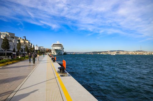 Free A scenic view of a cruise ship docked at the bustling Istanbul promenade on a bright day. Stock Photo