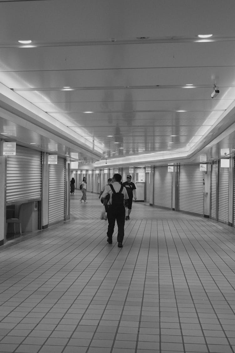 Man Walking In Tunnel In Black And White