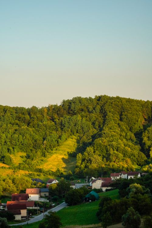 Free Peaceful view of a rural village in Samobor, Croatia surrounded by lush green hills. Stock Photo