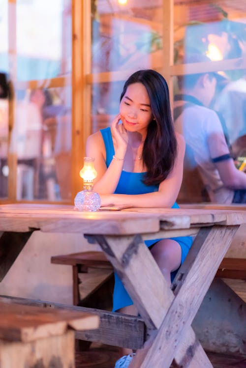 Kostnadsfri bild av asiatisk kvinna, blå klänning, bord