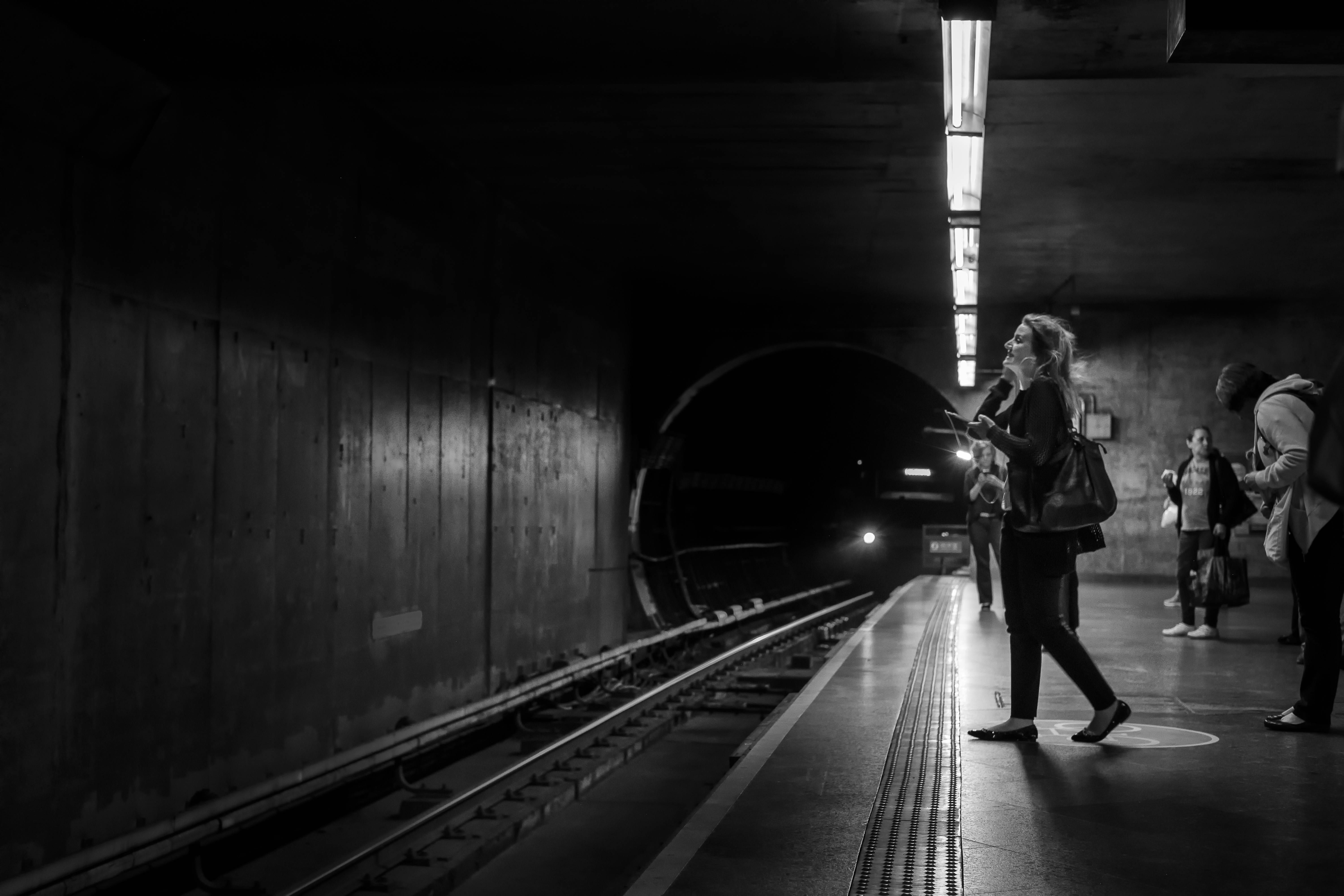 Monochrome Photo of People Standing In Subway