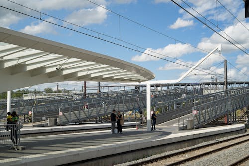 Modern Railway Station Platform with Elevated Walkways in the Background