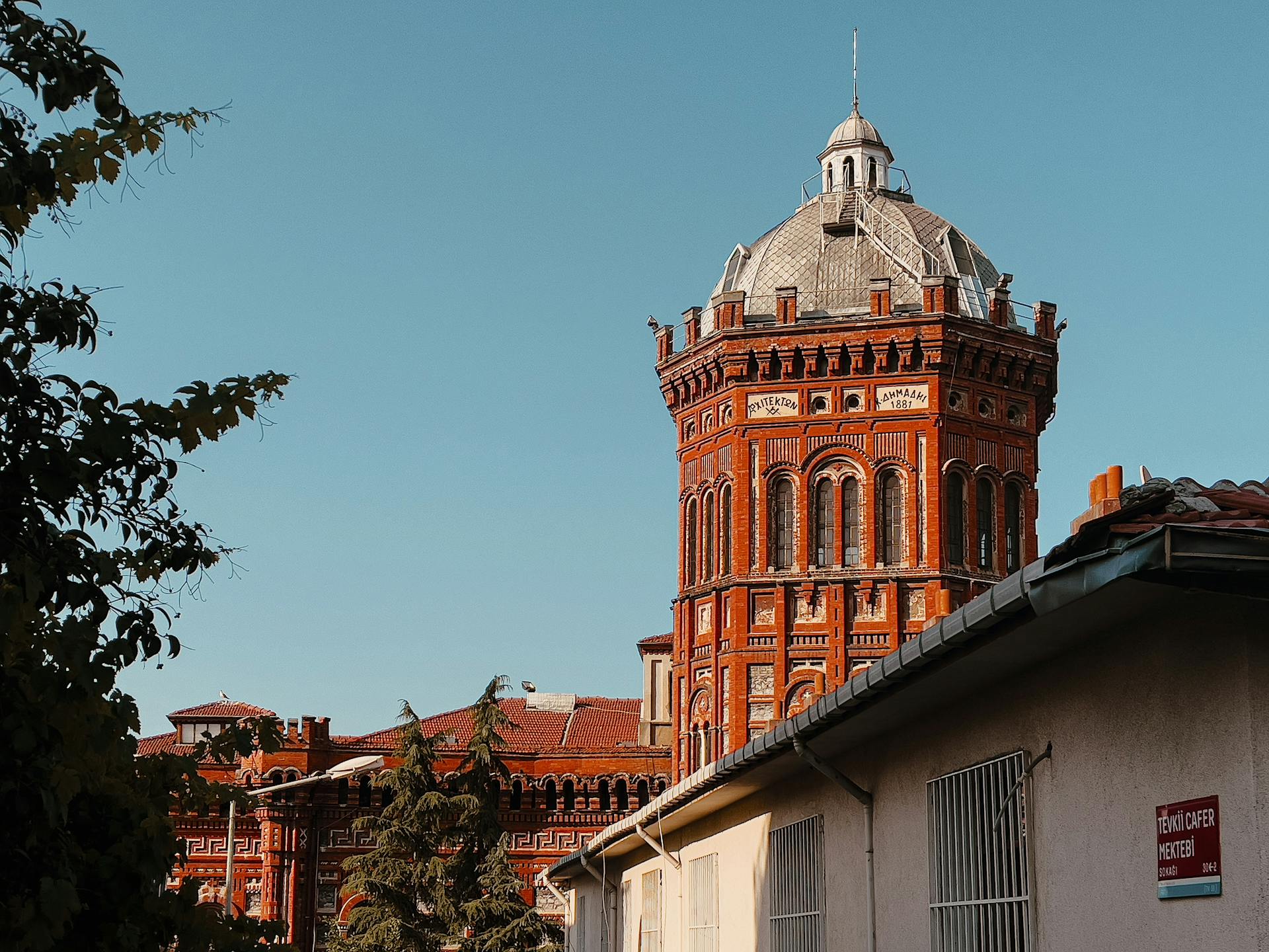 Exterior view of a historic red brick building in Istanbul under a clear blue sky